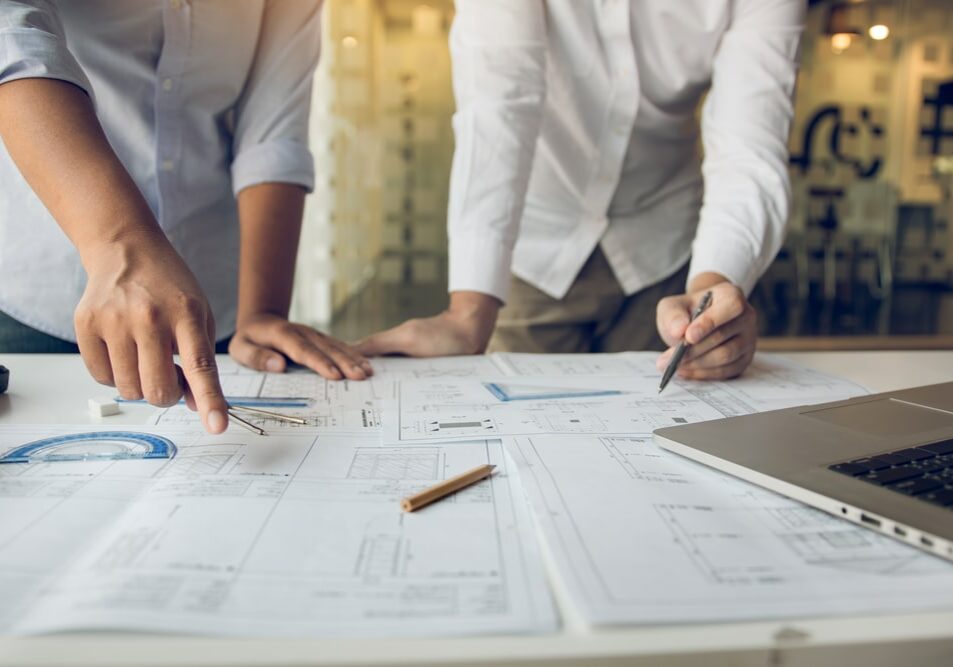 Engineers,Are,Helping,To,Design,Work,On,Blueprints,And,Collaborate